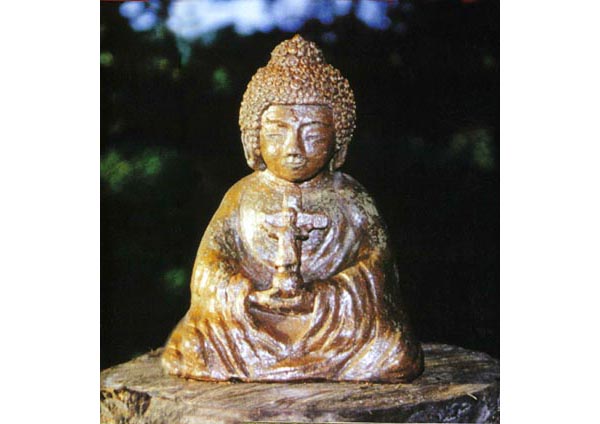 A statue of Buddha holding a crucifix